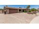 Single-story home with brick accents, desert landscaping, and a spacious driveway at 8620 E Sells Dr, Scottsdale, AZ 85251