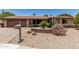 Single-story home featuring xeriscaping, brick accents, and desert vegetation in the front yard at 8620 E Sells Dr, Scottsdale, AZ 85251