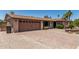 Single-story home with brick accents and drought-tolerant landscaping, plus a spacious driveway at 8620 E Sells Dr, Scottsdale, AZ 85251