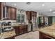 Well-appointed kitchen features stainless steel appliances, granite counters, and dark wood cabinetry at 8620 E Sells Dr, Scottsdale, AZ 85251
