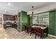 Eat-in kitchen boasts stainless steel appliances, granite counters, and dark wood cabinetry, adjacent to a cozy dining area at 8620 E Sells Dr, Scottsdale, AZ 85251