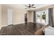 Open living room with wood floors, neutral walls, ceiling fan and view to bathroom and outdoor space at 8620 E Sells Dr, Scottsdale, AZ 85251