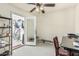 Bright home office with lots of natural light, view to garage storage, and a ceiling fan at 8620 E Sells Dr, Scottsdale, AZ 85251