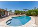 Gorgeous pool featuring a baja step, with palm trees and lush greenery creating a serene oasis at 8620 E Sells Dr, Scottsdale, AZ 85251