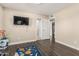Empty room with wood floors, view of the entrance to other rooms, and a mounted television at 8620 E Sells Dr, Scottsdale, AZ 85251