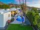 Beautiful backyard featuring a sparkling pool, lush lawn, shaded pergola, and a tennis court at 908 W Pershing Ave, Phoenix, AZ 85029