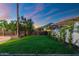 Lush green lawn, mature landscaping and mountain views create a tranquil outdoor space at 908 W Pershing Ave, Phoenix, AZ 85029