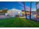 Expansive backyard featuring lush lawn and a sparkling pool for relaxation and outdoor enjoyment at 908 W Pershing Ave, Phoenix, AZ 85029