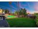 Well-manicured lawn with a pool, pergola, and mature trees, offering privacy at 908 W Pershing Ave, Phoenix, AZ 85029