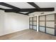 Minimalist bedroom design with black beams and sliding closet doors that offer ample storage space at 908 W Pershing Ave, Phoenix, AZ 85029
