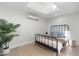 Cozy bedroom featuring a skylight, wooden floors, indoor plants, and a modern bed frame at 908 W Pershing Ave, Phoenix, AZ 85029