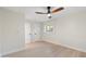 Simple bedroom with light hardwood flooring, ceiling fan, and white painted trim and walls at 908 W Pershing Ave, Phoenix, AZ 85029