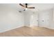 Simple bedroom with light hardwood flooring, ceiling fan, and white painted trim and walls at 908 W Pershing Ave, Phoenix, AZ 85029