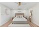 Bright bedroom featuring neutral color palette, fan, carpet, and stylish decor with plenty of natural light at 908 W Pershing Ave, Phoenix, AZ 85029