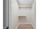 A walk-in closet with hardwood floor and wooden shelf and rail at 908 W Pershing Ave, Phoenix, AZ 85029