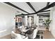 Open-concept dining room with exposed beams, a seamless flow to the kitchen and living area, perfect for gatherings at 908 W Pershing Ave, Phoenix, AZ 85029