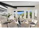 Bright dining room featuring a modern table setting, view windows, and dark wood beam accents at 908 W Pershing Ave, Phoenix, AZ 85029
