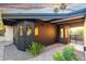 Eye-catching home exterior with dark wood, a pathway, and desert landscaping set against a colorful sky at 908 W Pershing Ave, Phoenix, AZ 85029