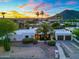 Desert home with palm trees, cactus, and a circular driveway at sunset at 908 W Pershing Ave, Phoenix, AZ 85029