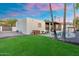 Beautiful backyard with a well-manicured lawn, pool, outdoor kitchen, and a desert landscape at 908 W Pershing Ave, Phoenix, AZ 85029