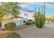 Scenic desert landscape with lush greenery surrounding the home's exterior creating a unique and inviting outdoor space at 908 W Pershing Ave, Phoenix, AZ 85029