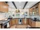 Updated kitchen with natural wood cabinetry, stainless steel appliances, and black countertops at 908 W Pershing Ave, Phoenix, AZ 85029