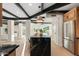 Kitchen with dark marble island, stainless steel refrigerator, and hardwood floors in open floor plan at 908 W Pershing Ave, Phoenix, AZ 85029