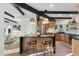 Modern kitchen with island, black marble counters, wooden cabinets, and stainless steel appliances at 908 W Pershing Ave, Phoenix, AZ 85029