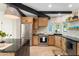 Updated kitchen featuring stainless steel appliances, wood cabinetry, and a central island at 908 W Pershing Ave, Phoenix, AZ 85029