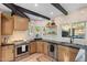 Well-lit kitchen with wood cabinets, stainless steel appliances, and stylish tile backsplash at 908 W Pershing Ave, Phoenix, AZ 85029