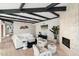 Cozy living space with a stone fireplace, wood floors, and stylish white couches at 908 W Pershing Ave, Phoenix, AZ 85029