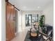 Contemporary living room showcasing a sliding barn door, modern furniture, and a walk out patio at 908 W Pershing Ave, Phoenix, AZ 85029