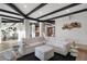 Bright living room with wooden floors and beamed ceilings complemented by stylish white furniture at 908 W Pershing Ave, Phoenix, AZ 85029