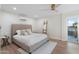 Bedroom features a queen bed, ceiling fan, and sliding door to the balcony at 908 W Pershing Ave, Phoenix, AZ 85029