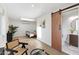 Bright bedroom with light hardwood flooring, ensuite bathroom with modern sliding barn door at 908 W Pershing Ave, Phoenix, AZ 85029