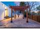 Outdoor kitchen with a built-in grill and a shaded pergola, perfect for entertaining at 908 W Pershing Ave, Phoenix, AZ 85029