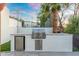 Outdoor kitchen featuring a stainless steel grill and mini-refrigerator, perfect for outdoor entertaining at 908 W Pershing Ave, Phoenix, AZ 85029