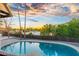 Stunning pool with palm trees and a dramatic sunset view at 908 W Pershing Ave, Phoenix, AZ 85029