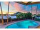 Inviting pool area with palm trees and scenic sunset backdrop; ideal for relaxation at 908 W Pershing Ave, Phoenix, AZ 85029