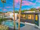 Beautiful backyard oasis featuring a sparkling pool, lush landscaping, and modern architectural details at 908 W Pershing Ave, Phoenix, AZ 85029