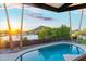 Tranquil pool view with mountain backdrop and palm trees at sunset at 908 W Pershing Ave, Phoenix, AZ 85029