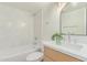 Beautiful bathroom featuring a modern vanity, updated fixtures, an elegant mirror, and a tiled shower-tub combination at 967 E Hearne Way, Gilbert, AZ 85234
