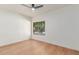 Minimalist bedroom with a large window overlooking greenery, complemented by light wood flooring at 967 E Hearne Way, Gilbert, AZ 85234