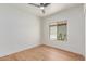 This bedroom features a modern ceiling fan, light hardwood floors, and a window overlooking a lush exterior at 967 E Hearne Way, Gilbert, AZ 85234