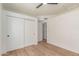 This bedroom features a ceiling fan, closet, and light hardwood floors, creating a comfortable and stylish space at 967 E Hearne Way, Gilbert, AZ 85234