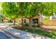Attractive single-story home showcases mature trees, a manicured lawn, and a paved sidewalk leading to the entrance at 967 E Hearne Way, Gilbert, AZ 85234