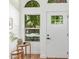 Bright foyer with natural light features a modern white front door and decorative arched windows at 967 E Hearne Way, Gilbert, AZ 85234