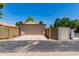 Exterior view of the garage showcasing its neutral tones and ample driveway space with desert landscaping at 967 E Hearne Way, Gilbert, AZ 85234