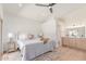 Relaxing bedroom with wood floors, fan, and ensuite bathroom offers a serene and comfortable space at 967 E Hearne Way, Gilbert, AZ 85234