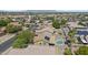 Wide aerial shot of a community featuring a home equipped with solar panels and a private pool at 10727 E El Moro Ave, Mesa, AZ 85208